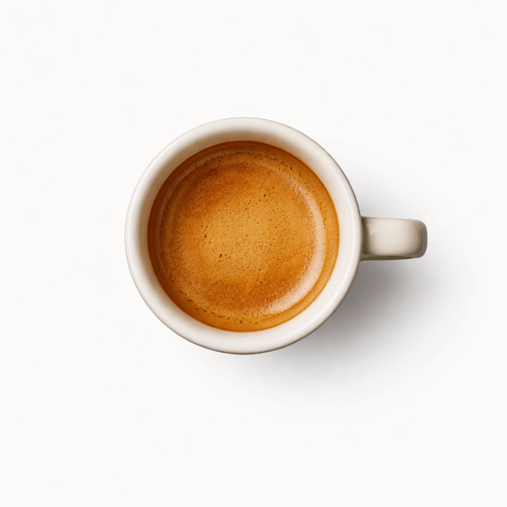 Top view of espresso with rich crema in a small ceramic cup on white background
